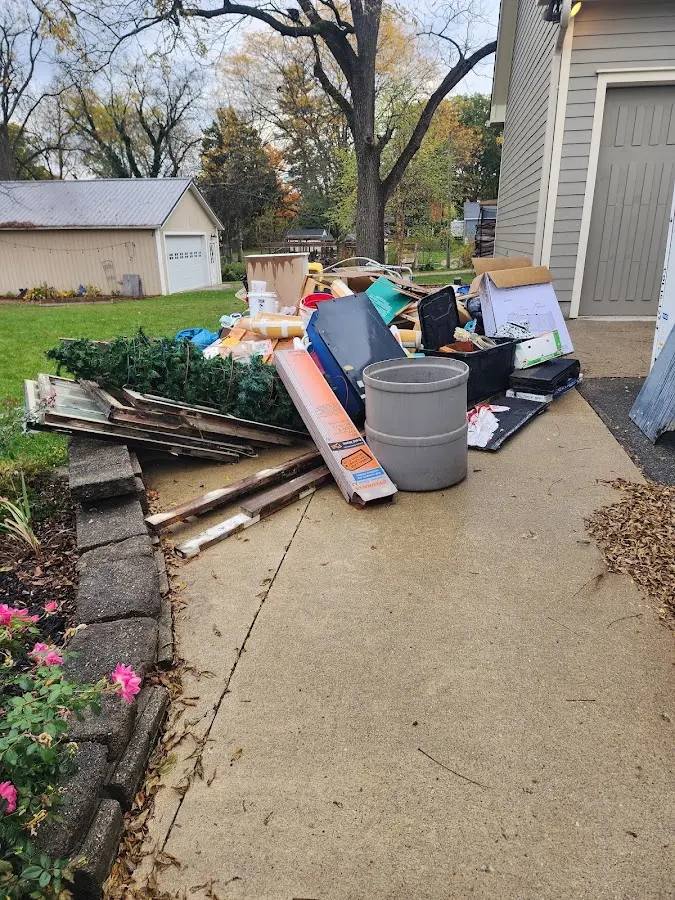 Dumpster being loaded with debris for Roofing Dumpster Rental in Bay City